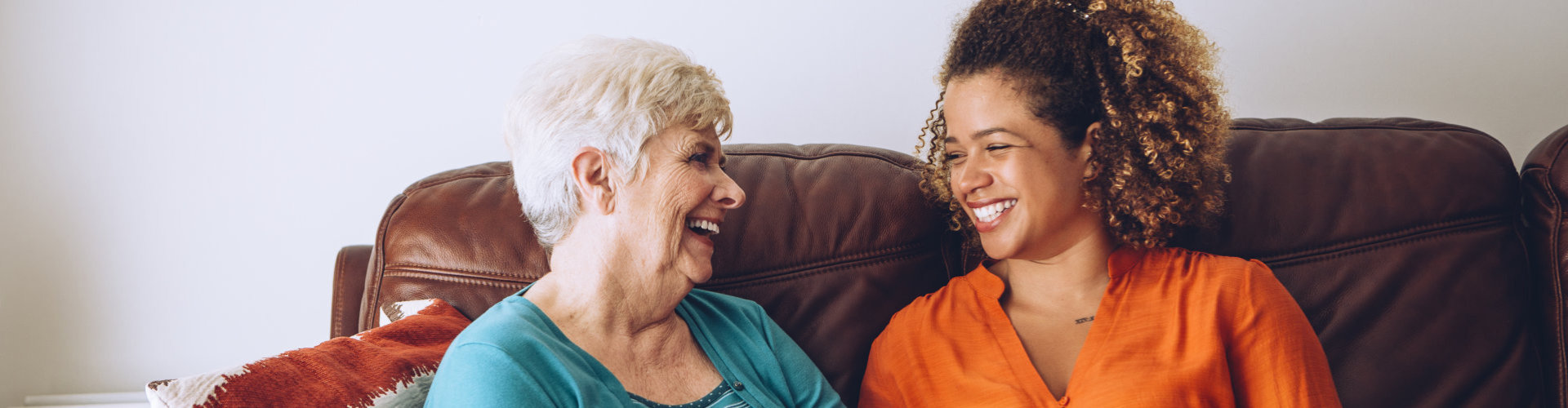 senior woman and her caregiver laughing